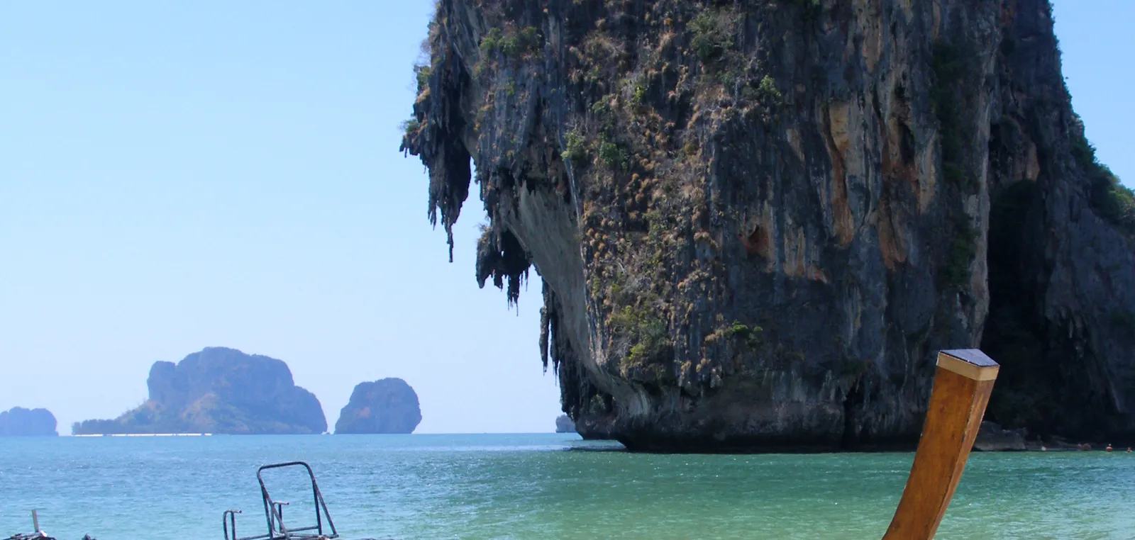 Limestone tower and sea stacks above turquoise shallows at Railay in Krabi