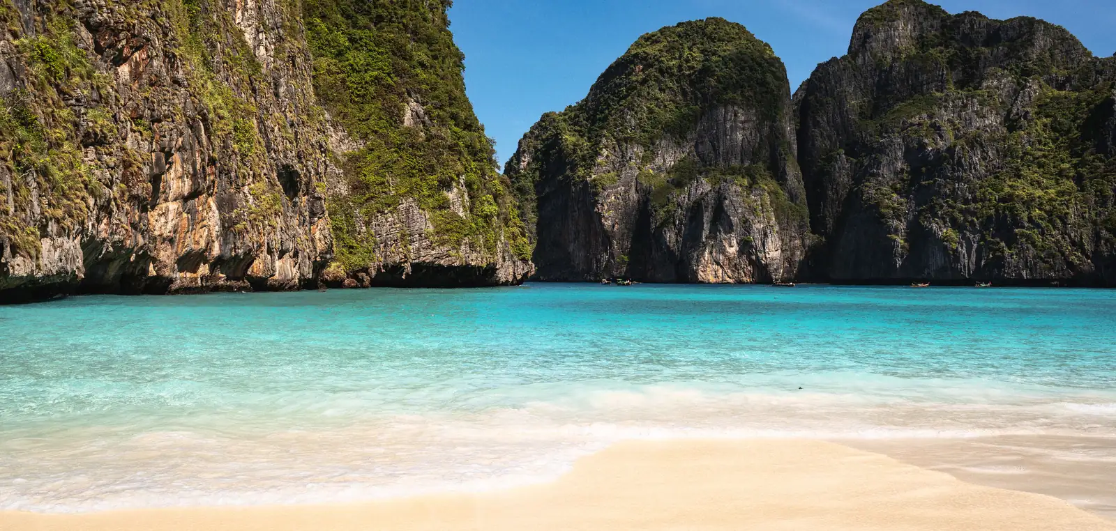 Clear shallow water and limestone headlands on Phi Phi in the dry season