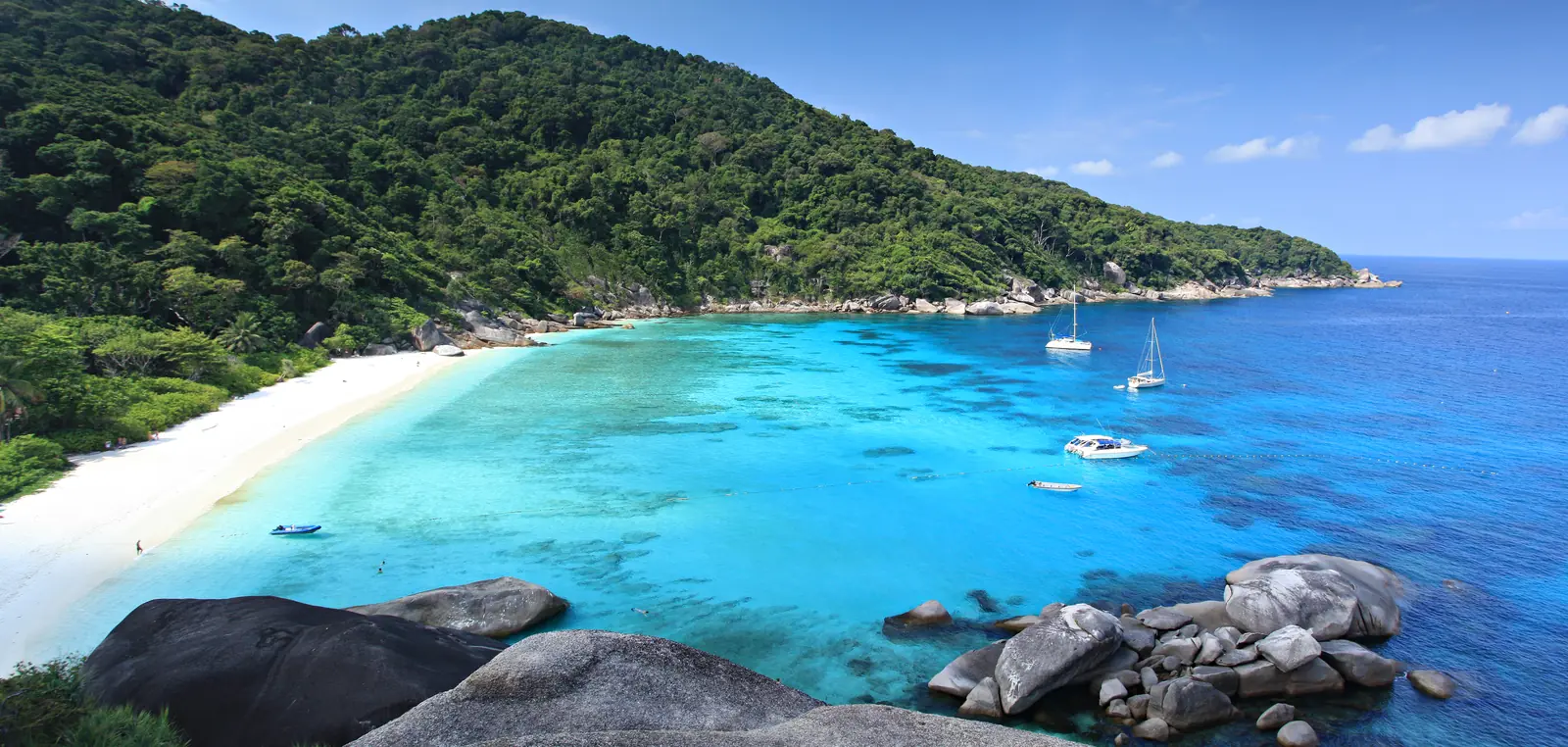 An empty Similan Islands beach and granite shoreline out of season